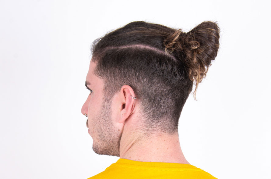 men’s top knot with curly undercut