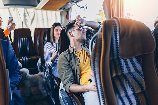 Men seating in bus traveling