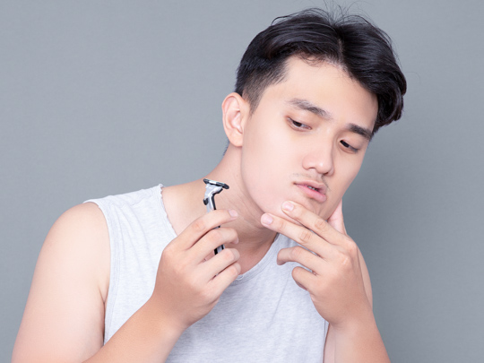 man shaving his beard