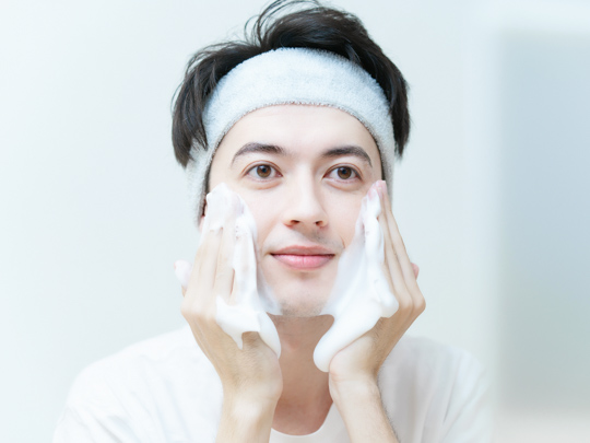 man with sensitive skin cleanses face